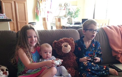 Notice how Oliver is already experiencing joy of Saturday morning gaming with the same look of surprise as big brother. PS: I think the bear is cheating. 