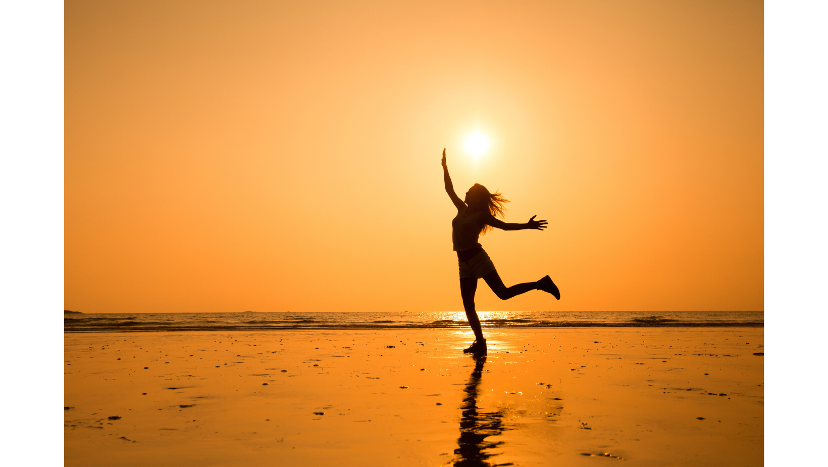 A person is posing playfully on a beach at sunset, with their arms raised and one leg bent, casting a shadow on the wet sand—perhaps unwinding after listening to Top LDS Podcast episodes.