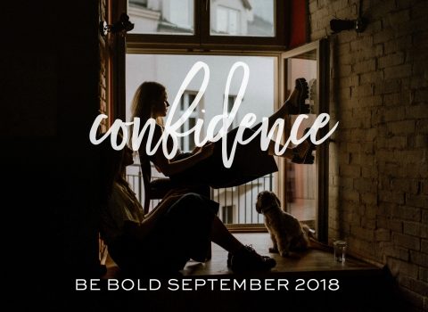 Two people sit by a large window with a dog; the word "confidence" is overlaid in script, with "Be Bold September 2018" at the bottom.
