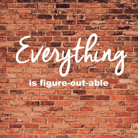 Text on a brick wall reads "Everything is figure-out-able" in large, handwritten and bold fonts.