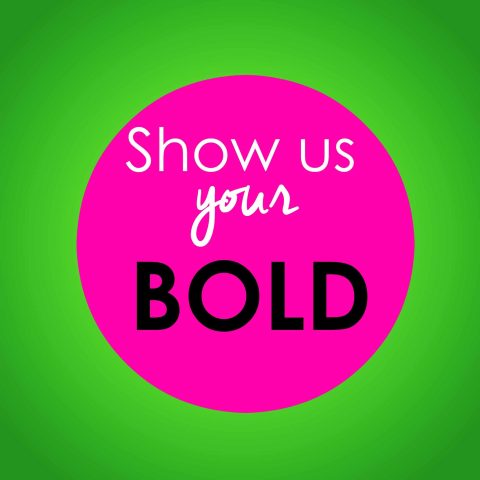 A bright pink circle with the words "Show us your BOLD" in white and black text, set against a green gradient background.